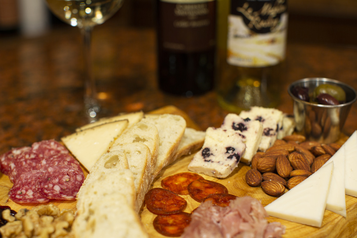 cheese and smoked meat plate, olives, almonds