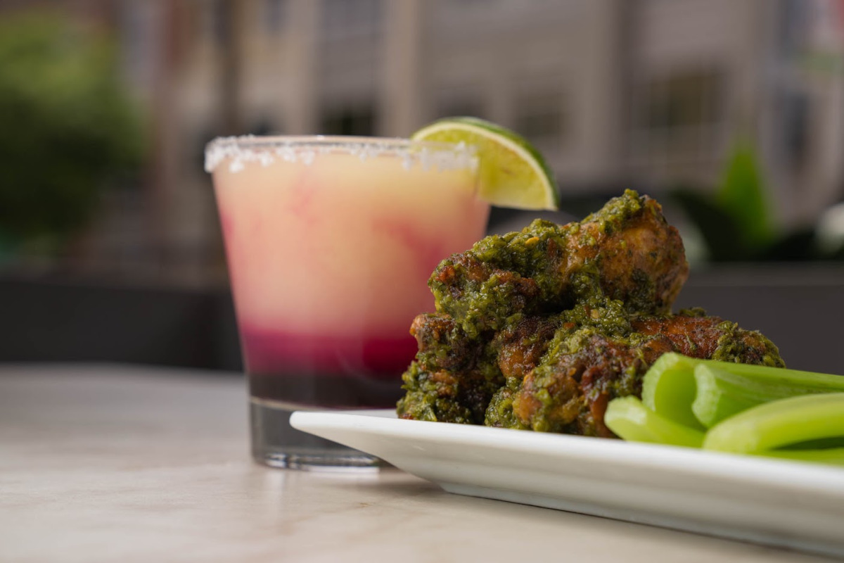 Chimichurri Wings served with a glass of cocktail