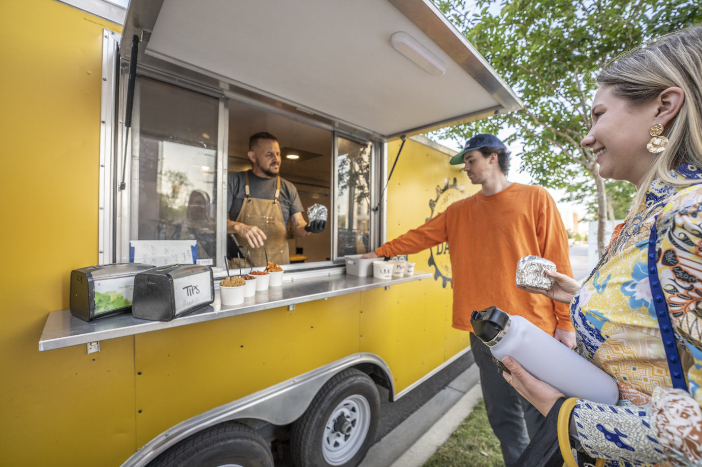 Employee serving customers from the food truck