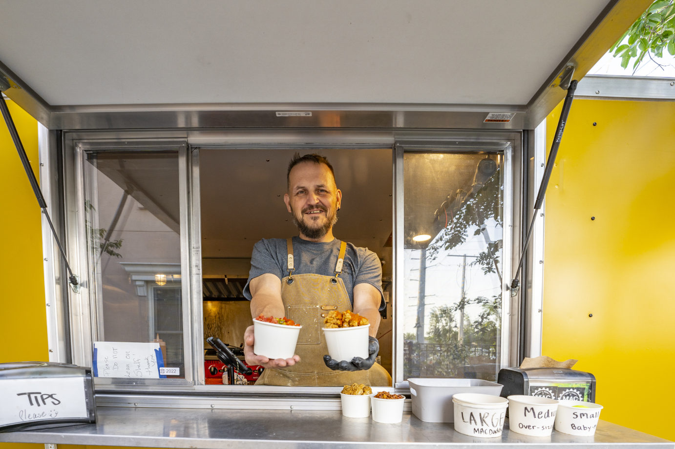 Exterior, an employee behind the food truck counter