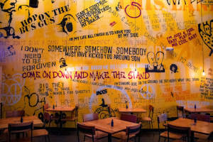Interior, tables and wall decorated with song lyrics