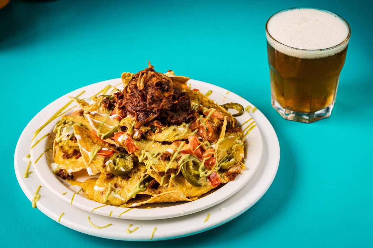 nachos in a plate and beer