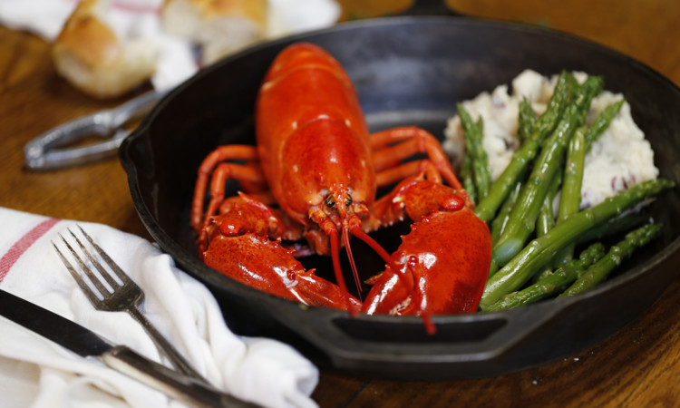Steamed whole lobster served with rice and asparagus