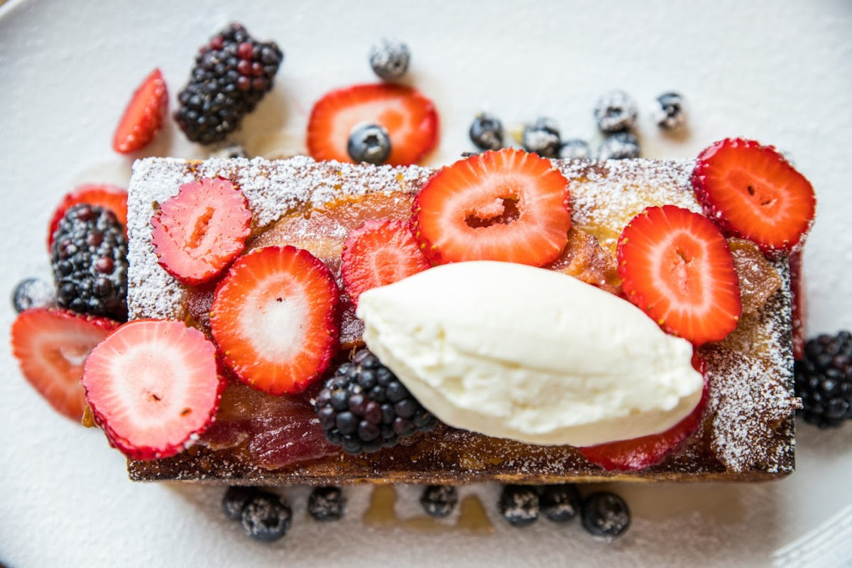 French Toast with vanilla bean syrup, crispy bacon, fresh berries, and whipped mascarpone cream 