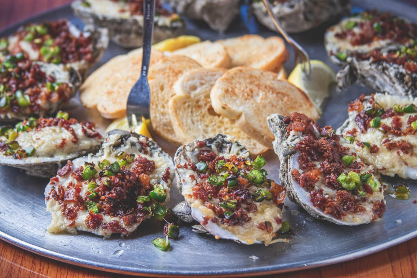 Oysters on the Half Shell topped with parmesan cheese, bacon, and jalapenos