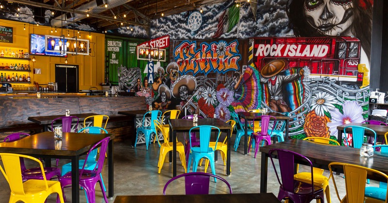 Interior, bar, dining tables, a large wall mural with Día de los Muertos motifs