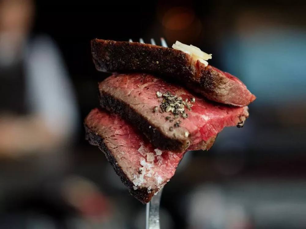 rump steak slices on a fork