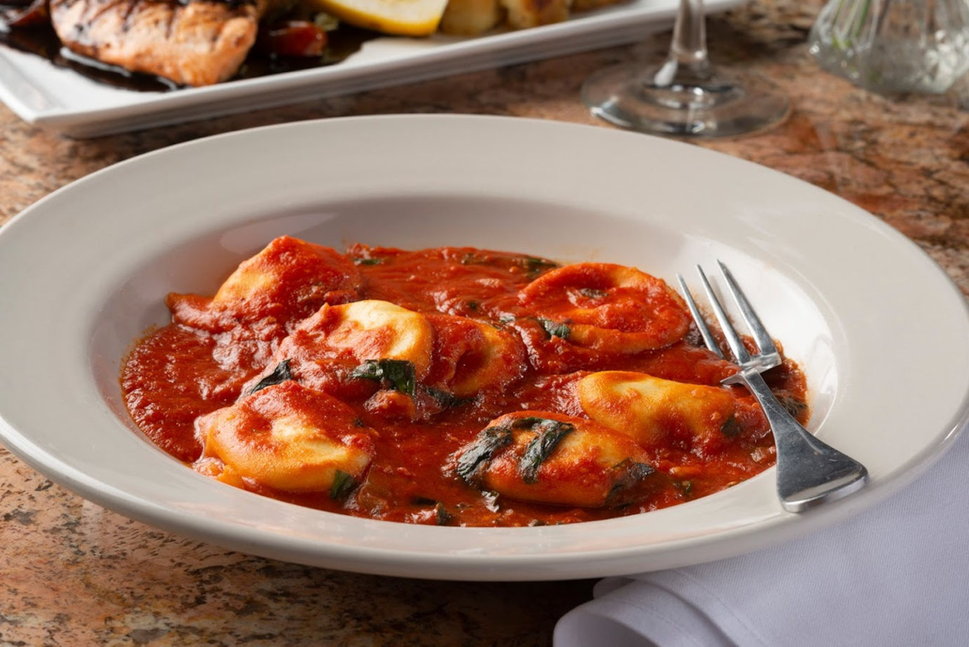 House-made ricotta-filled ravioli, tomato sauce and basil