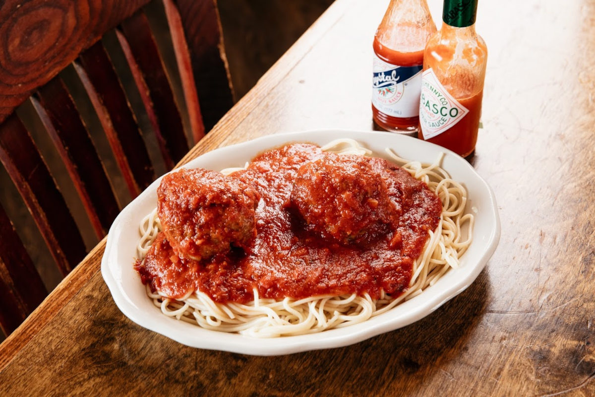 Spaghetti and meatballs covered with tomato sauce