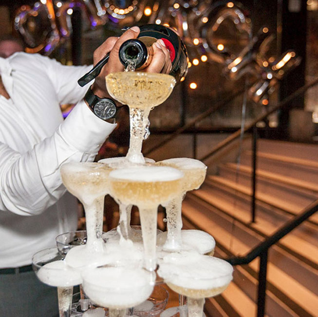 Employee pouring champagne