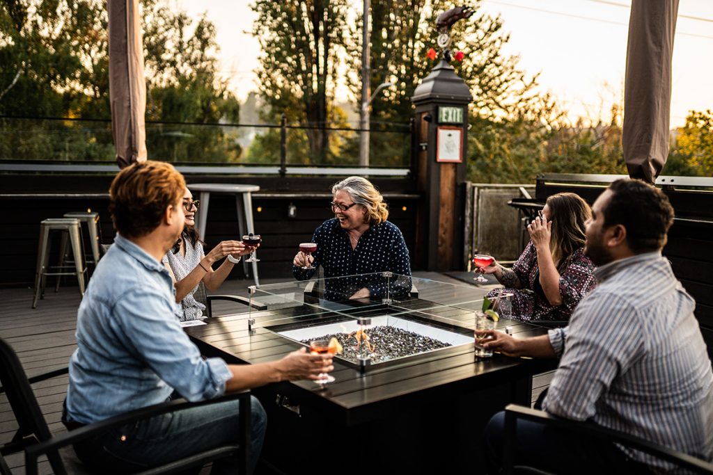 Outdoor rooftop, table with people