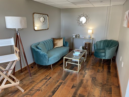 Bridal suite lounge with teal couch and modern decor