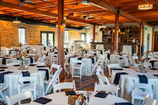 Wedding reception tables inside rustic venue hall