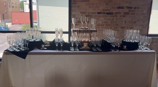 Champagne glasses displayed on bar table for wedding reception