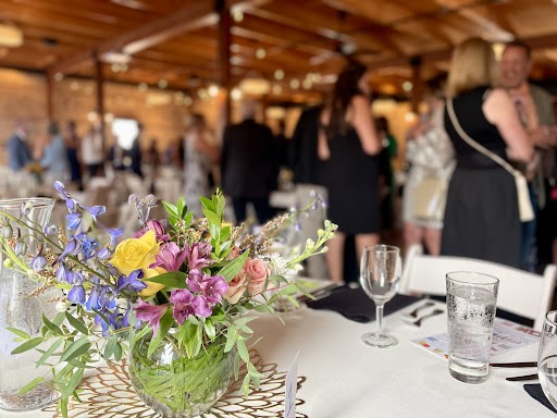 Reception floral centerpiece with guests in background