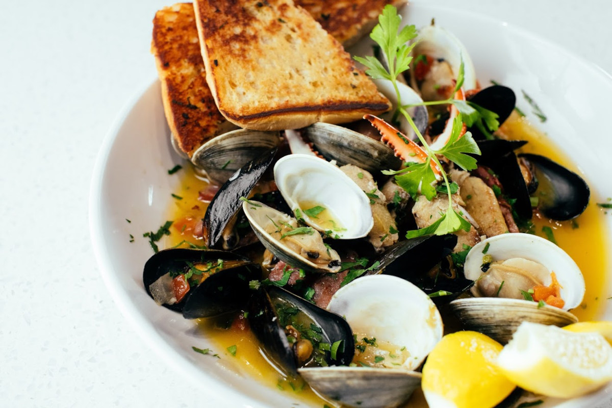 Mussels, clams, crab fingers, and sausage in a white-wine butter sauce