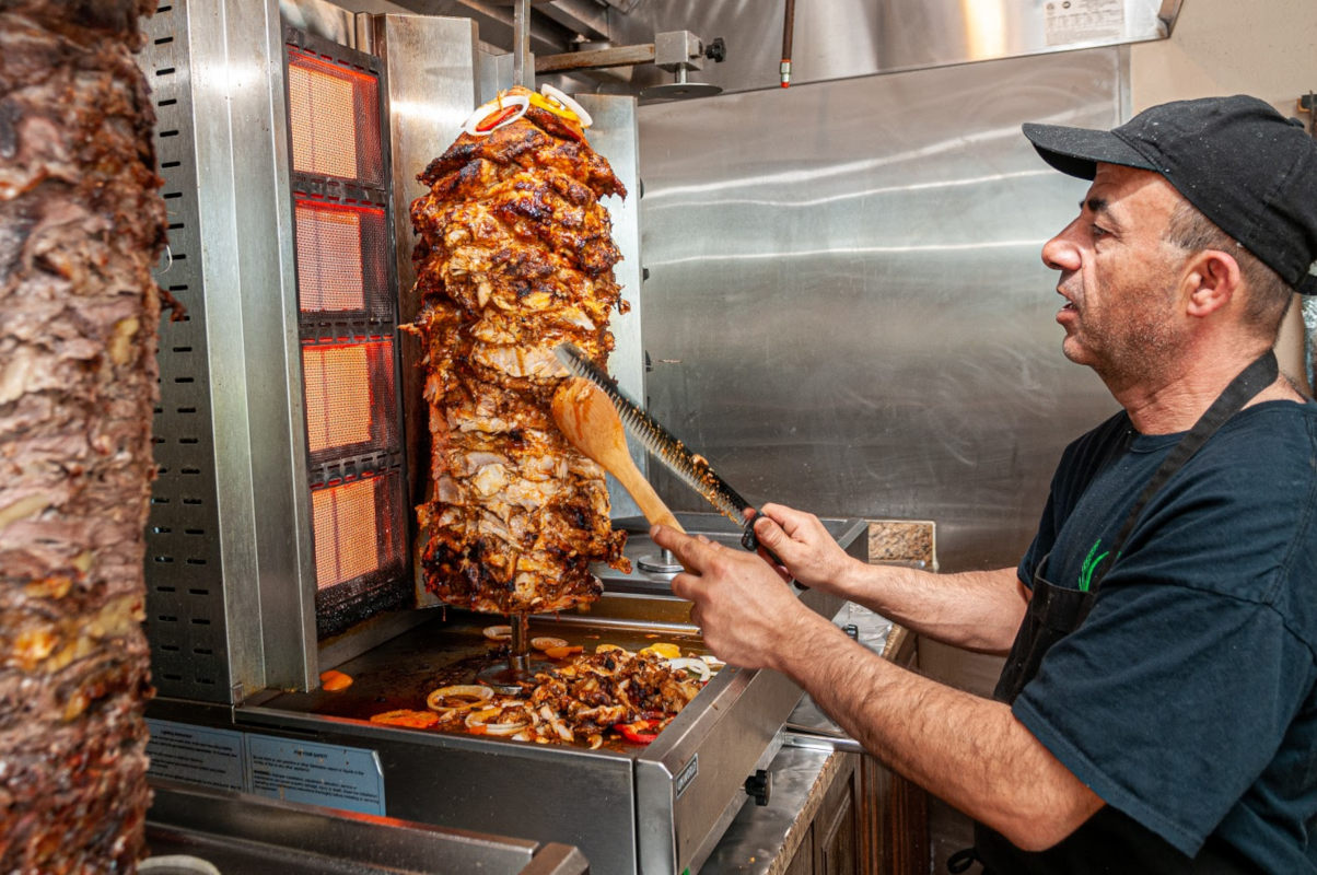 Staff member slicing kebab