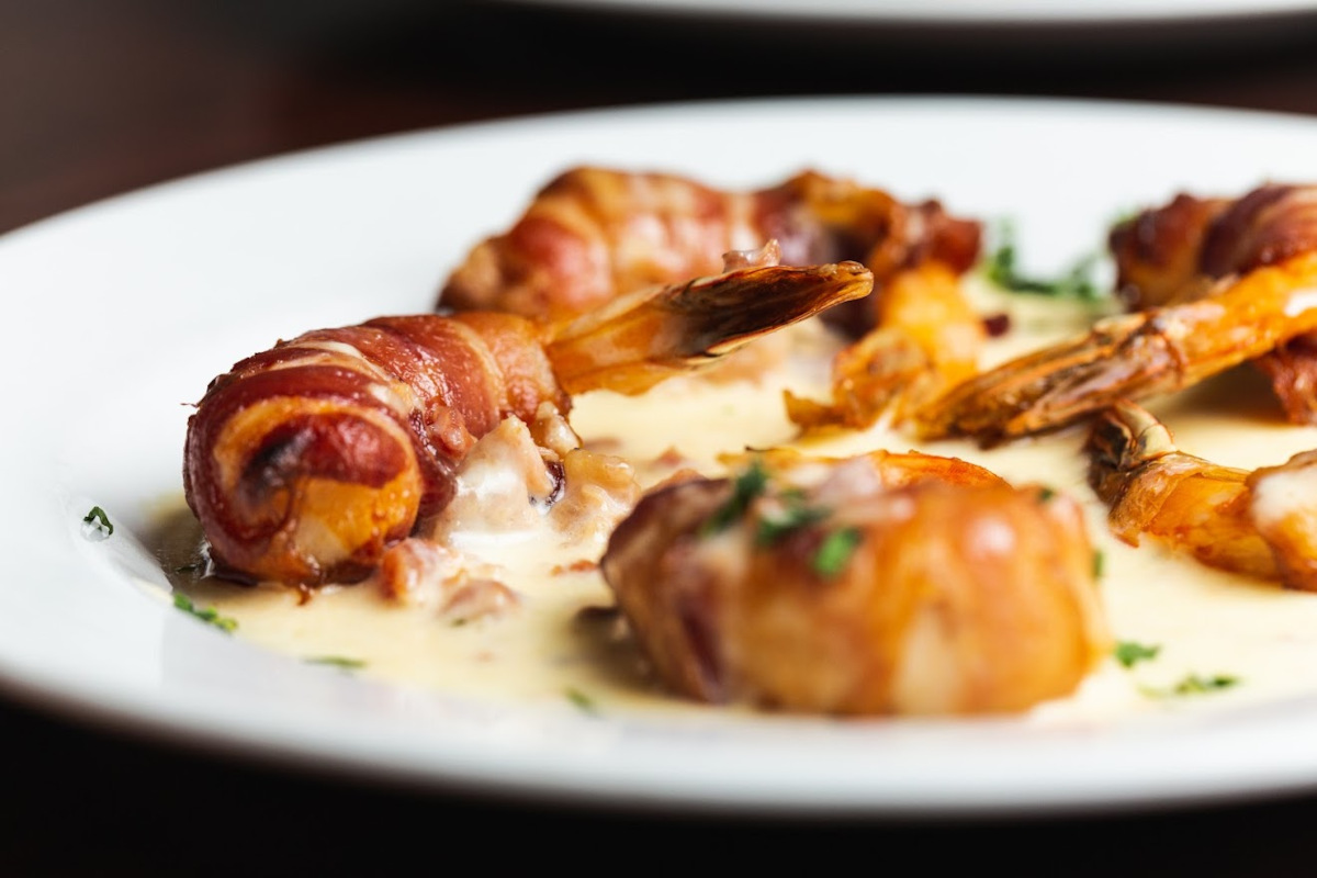 Applewood bacon wrapped shrimp topped with bacon bits