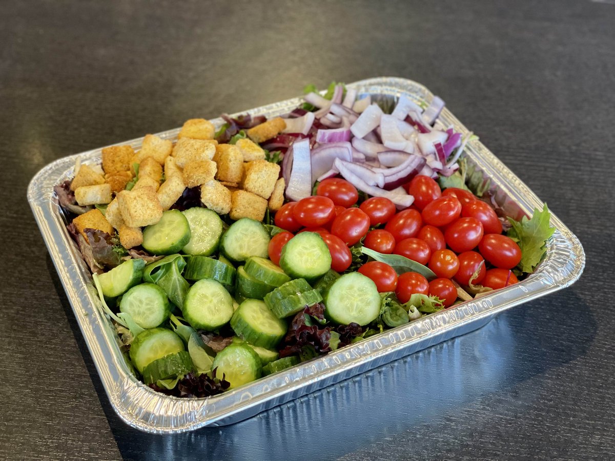 a tray of salad with vegetables