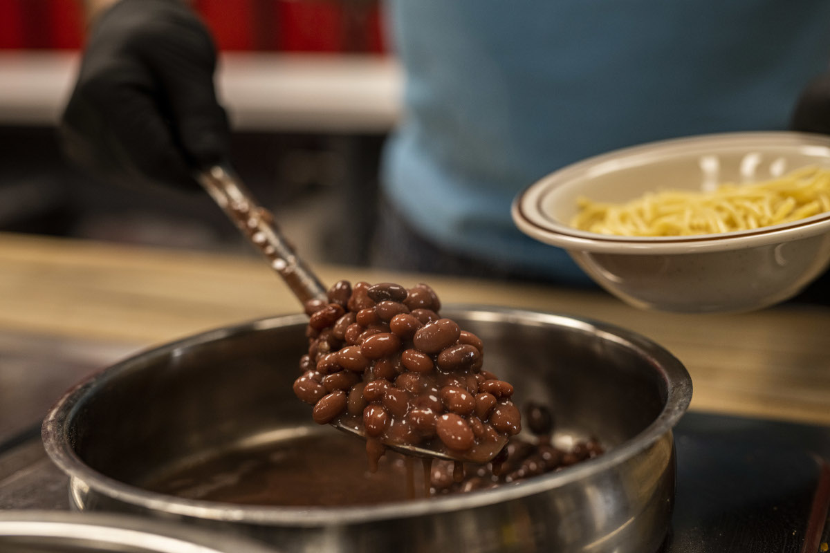 Staff member pouring beans into bowl