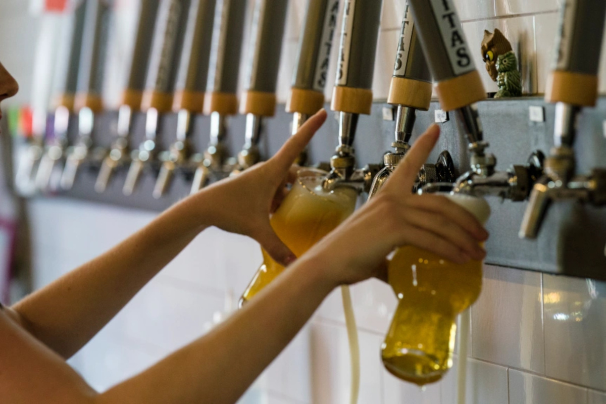 Pouring beer from beer wall taps, closeup