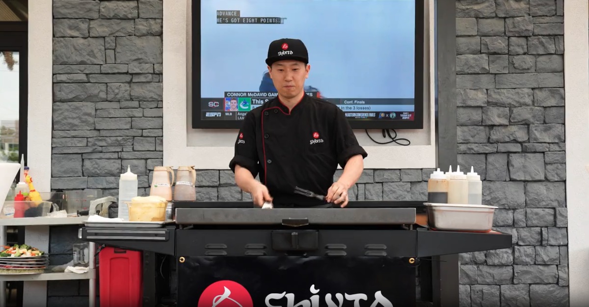 A chef at a hibachi grill station