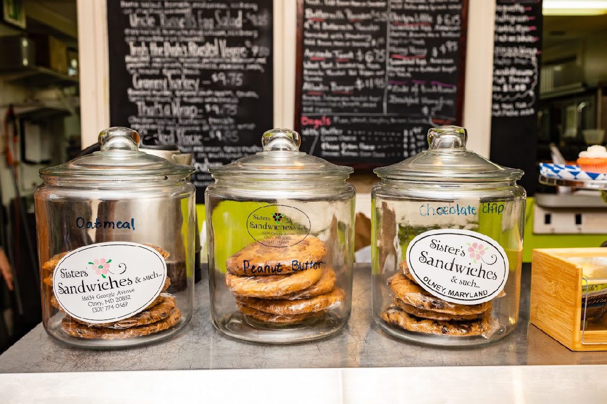 Glass jars with different cookies on a counter