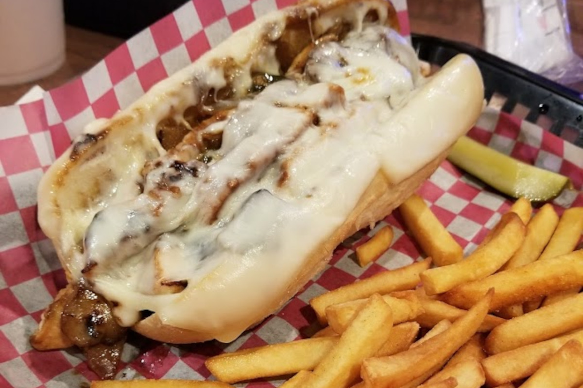 Philly cheesesteak sandwich and fries