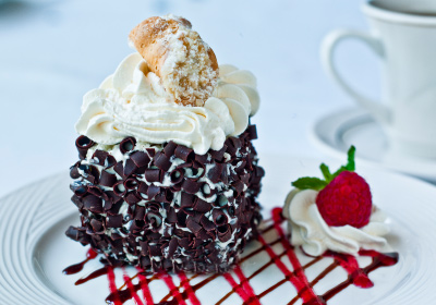 Chocolate chip cake topped with cream