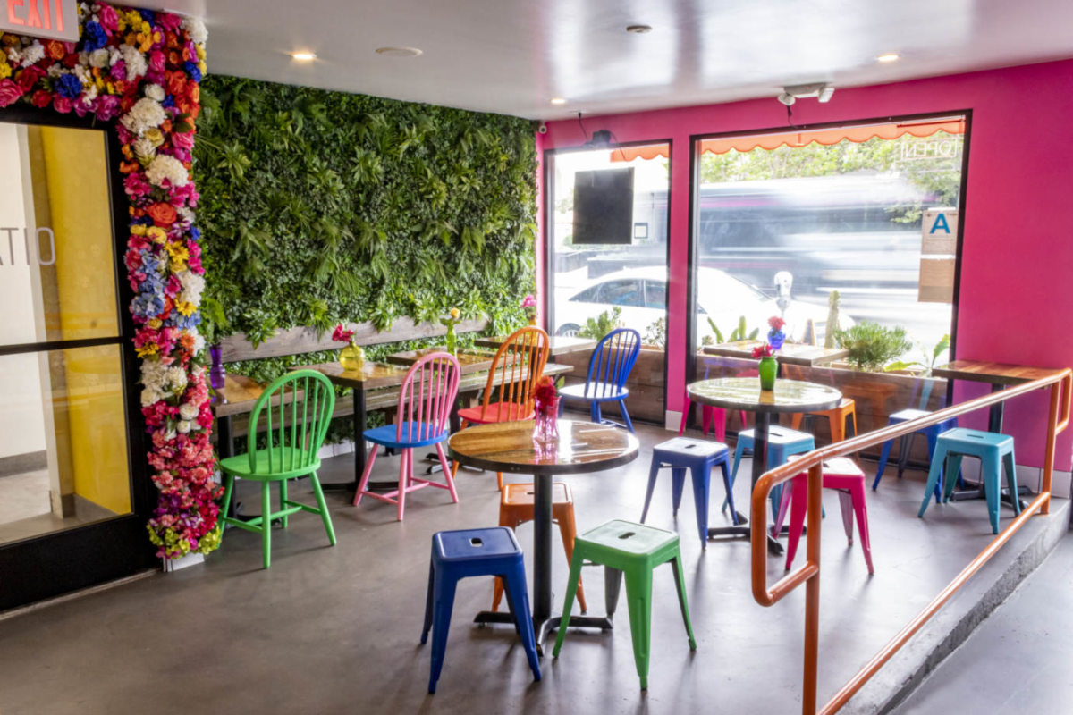 Interior, seating with faux greenery and colorful floral wall decor