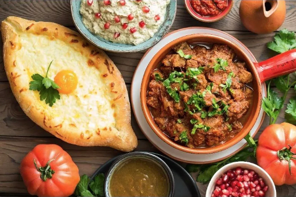 various meats, fresh bread, and vibrant vegetables.