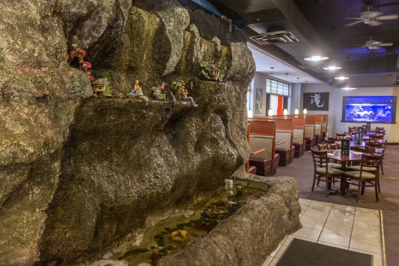Interior, a large decorative rock fountain at the dining area