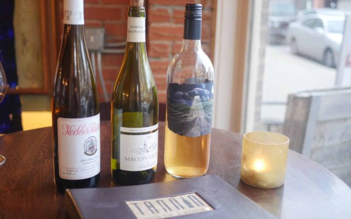  Wines on a table with a candle