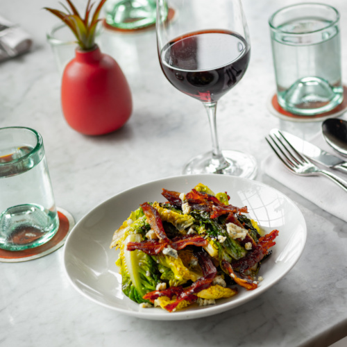 Little Gem Salad with pancetta and blue cheese and a glass of red wine