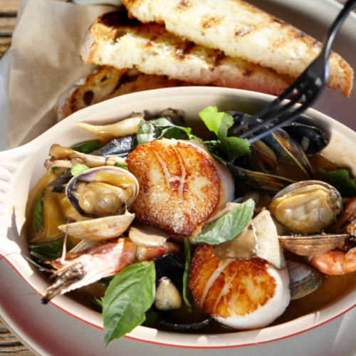 Seafood dish with toast, top view