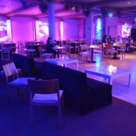 The officer's club interior with purple lights and tables