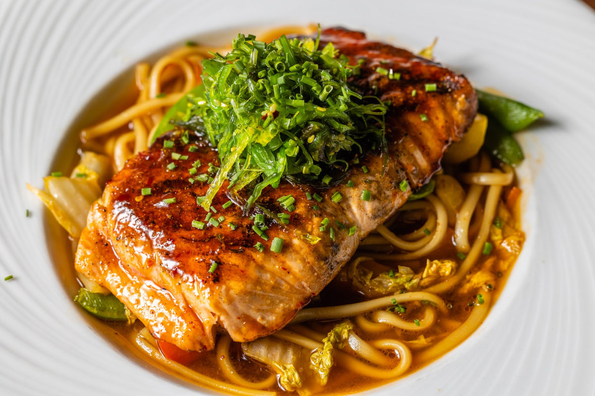 Salmon over veggie and noodles