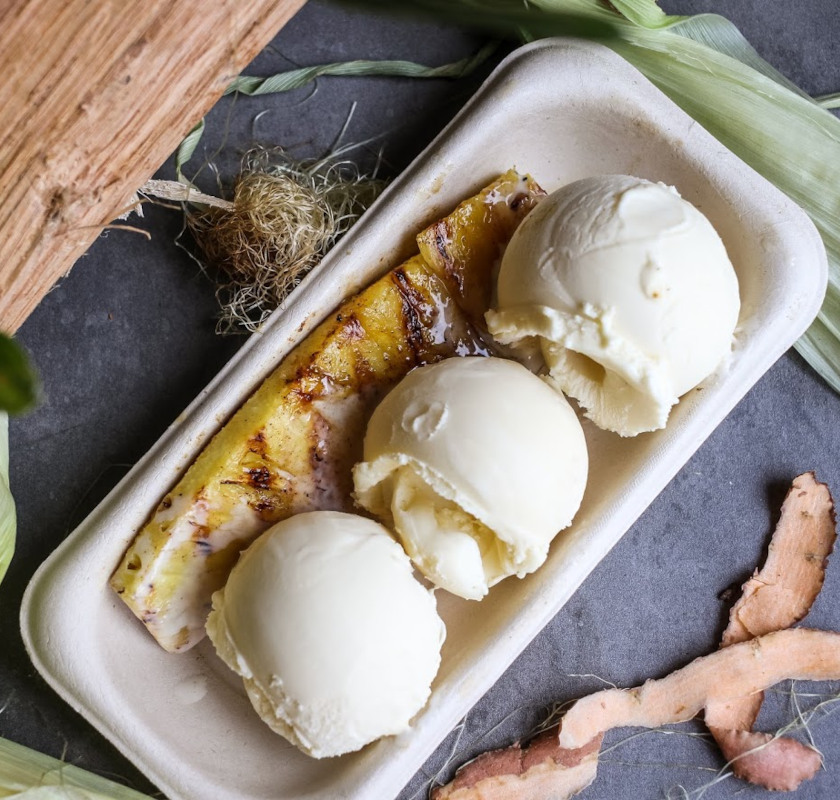 Grilled pineapple topped with vanilla bean ice cream