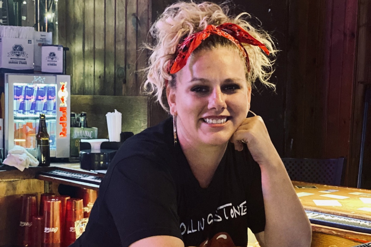 Bartender smiling behind counter, photo portrait