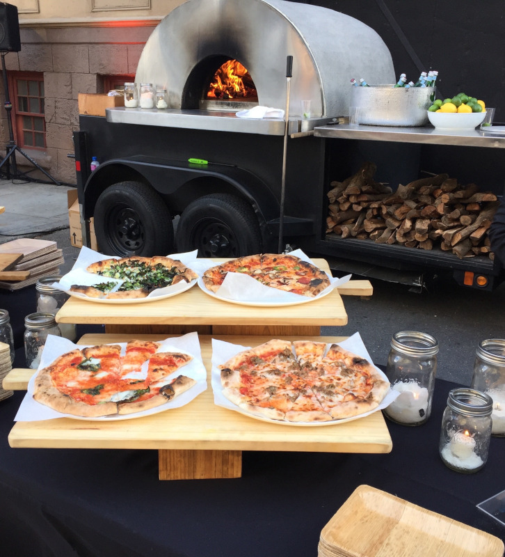 Various pizzas on the table, Pizza oven on the back