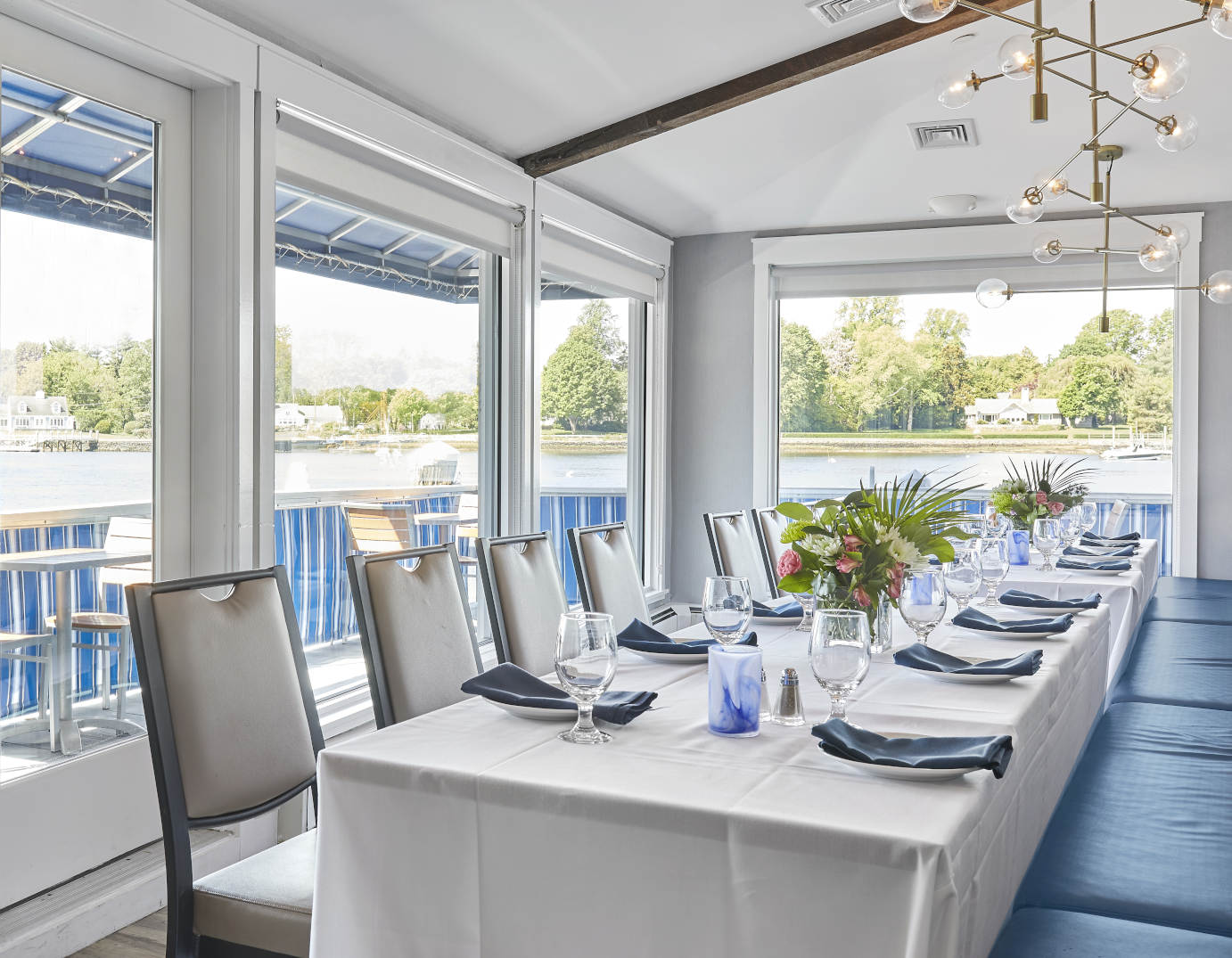 Interior, set dining table with chairs and upholstered seating by a window side