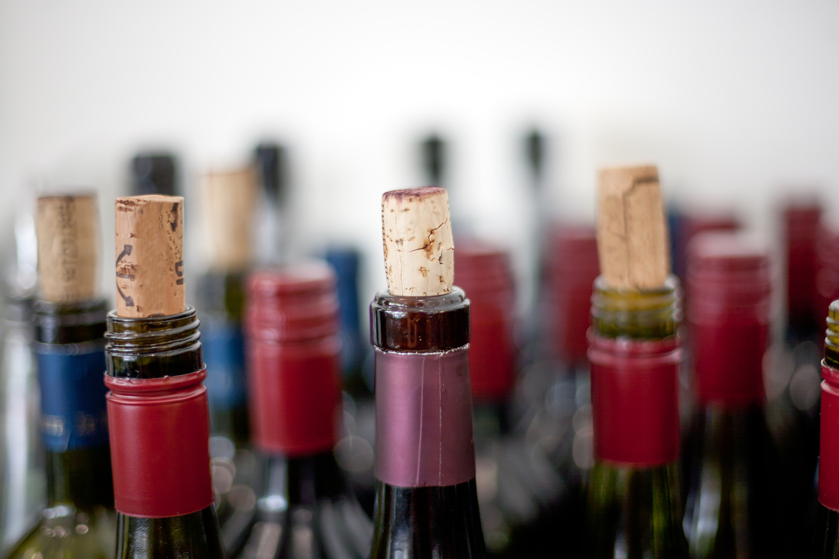 A group of wine bottles with corks