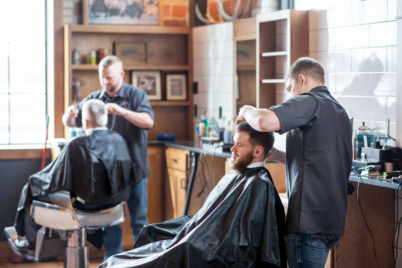 Two barbers cutting hair