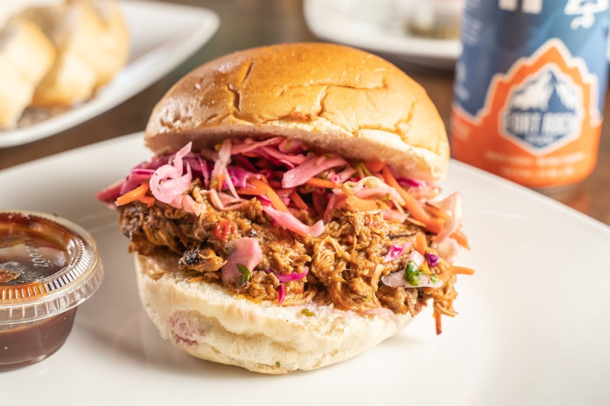 pulled pork sandwich with coleslaw on a bun