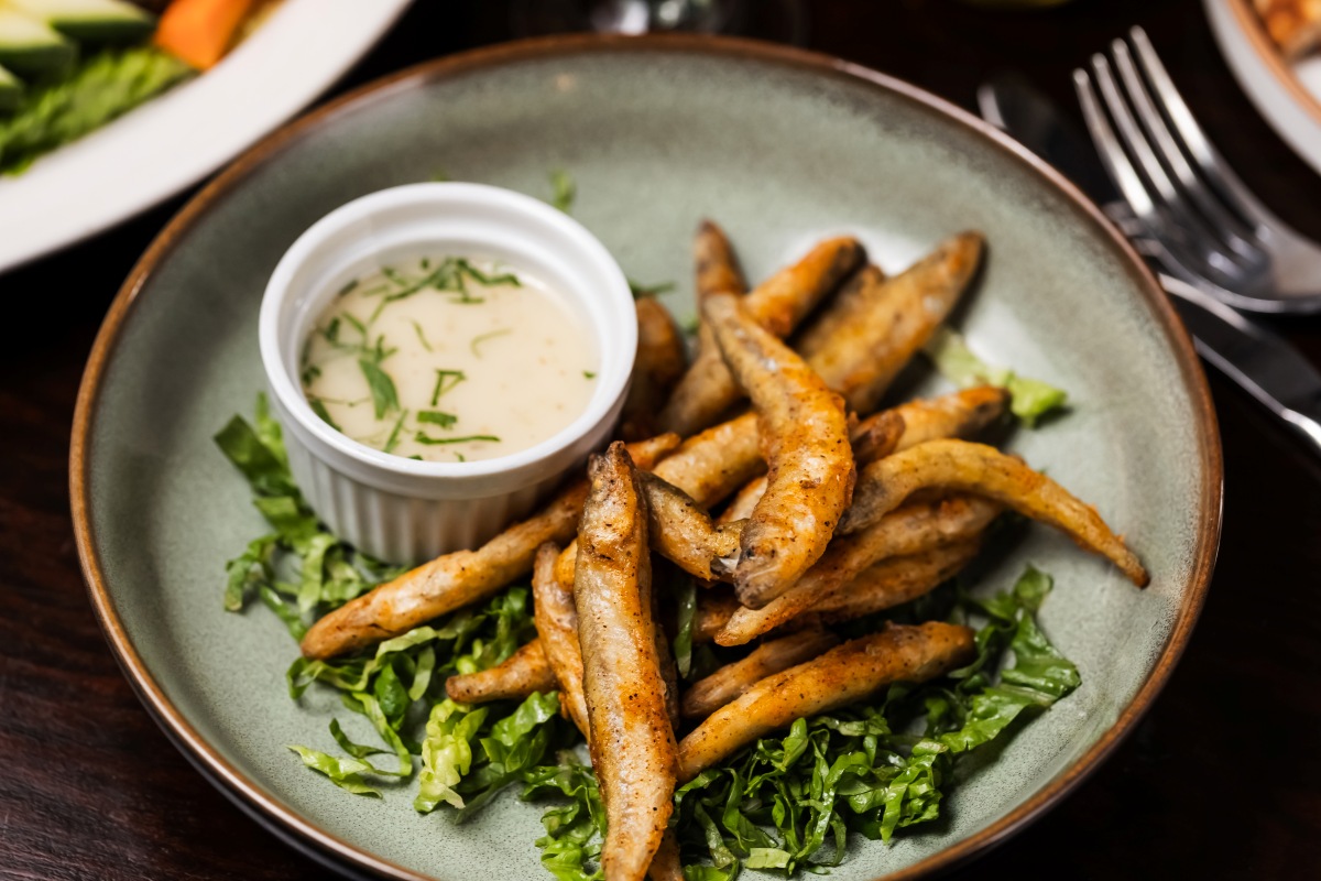 Seasoned fried whitebait on lettuce with creamy herb dipping sauce