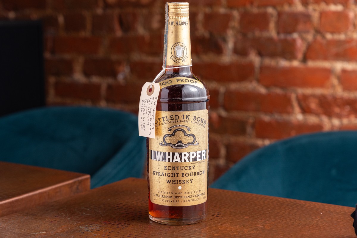 bottle of 1961 I.W Harper bourbon on a table