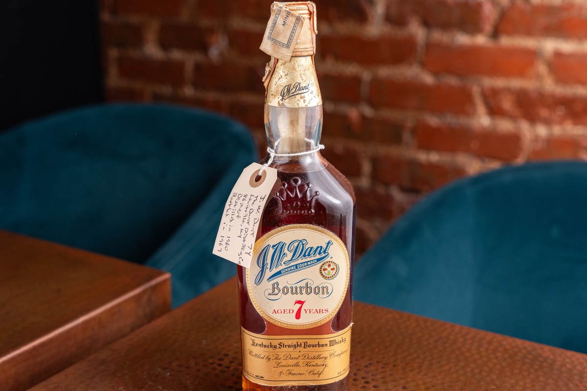 bottle of 1967 J.W. Dant bourbon on a table