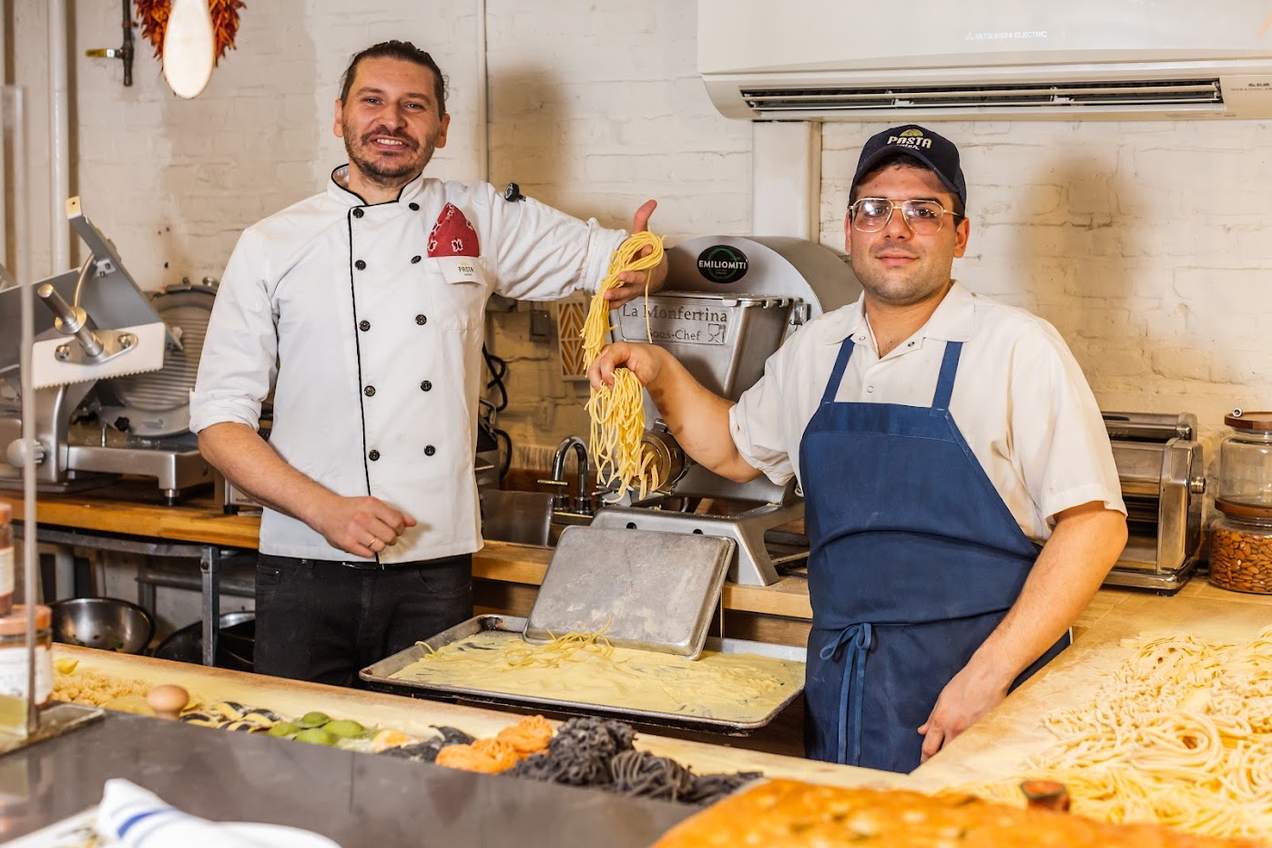 reataurant owners making fresh pasta dough