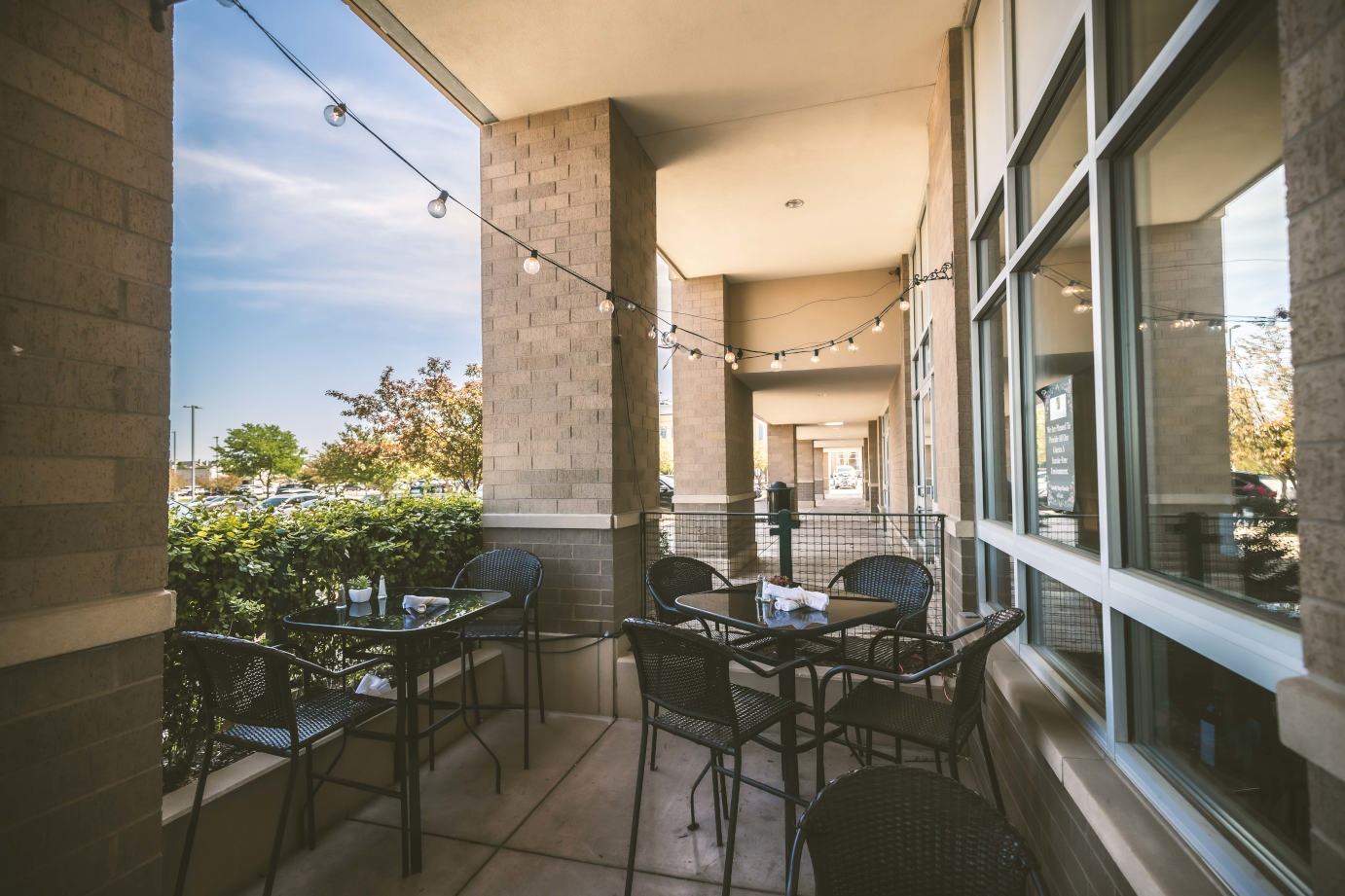 Exterior, covered patio with tables and chairs