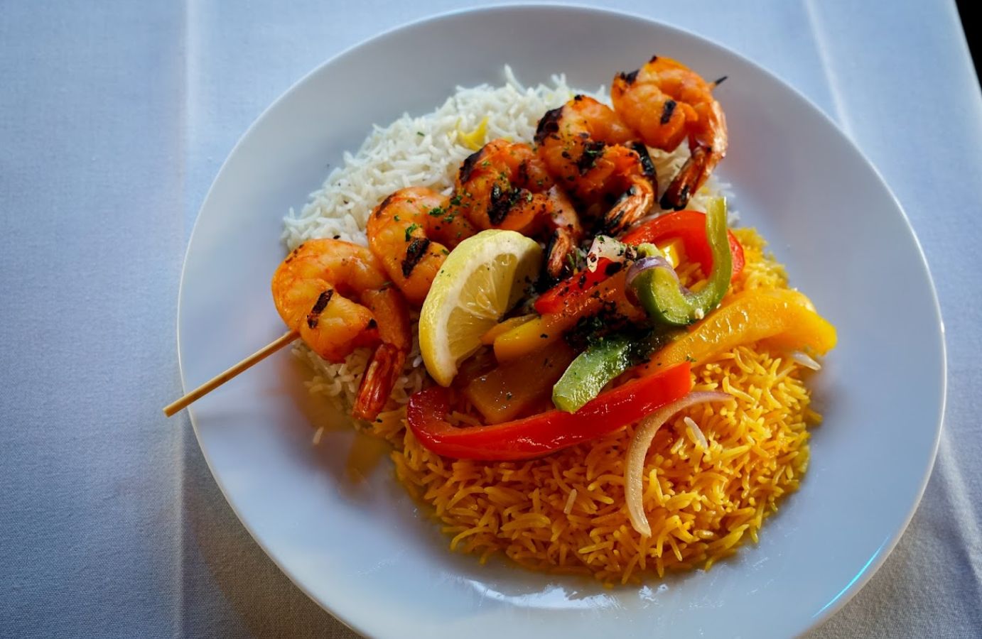 shrimp skewers with rice on a plate